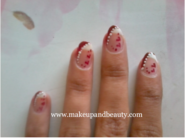I made few hearts on each nails , followed by placing red dots around the 