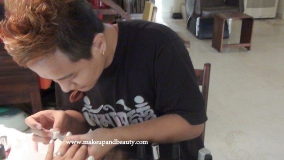 Cutie Nail Artist giving finishing touches