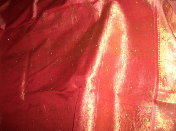 Kanjeevaram saree with gold, peach, and pink shades.