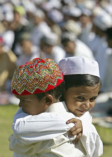 Muslim children hug each other after offering Eid al-Fitr prayers in Siliguri