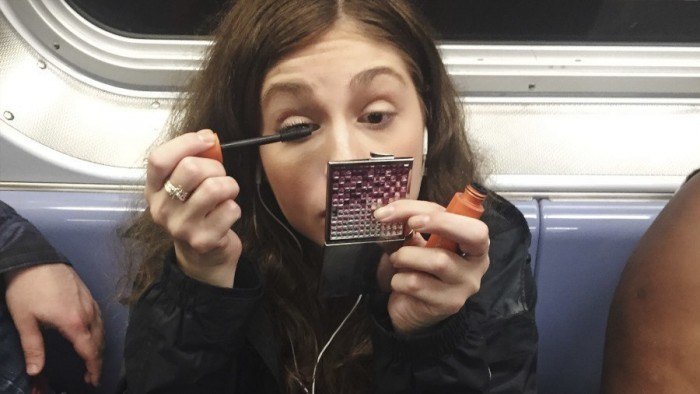girl applying mascara