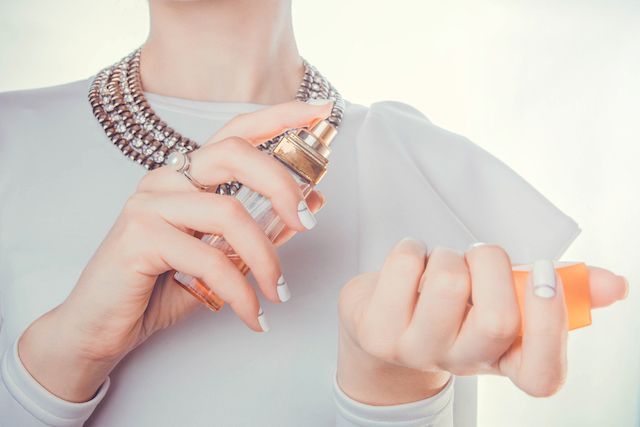 woman applying perfume