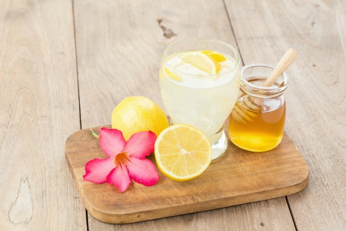 Lemon juice with honey on wooden table
