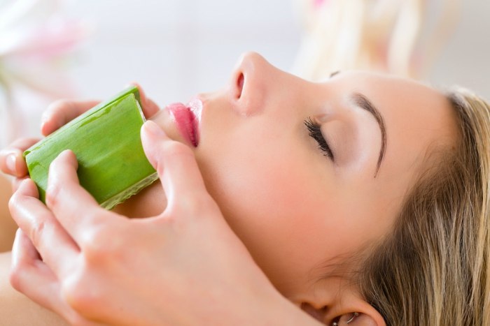 Wellness woman receiving head or face massage whit aloe Vera in spa