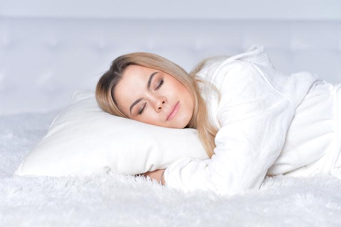 Woman sleeping on satin pillow