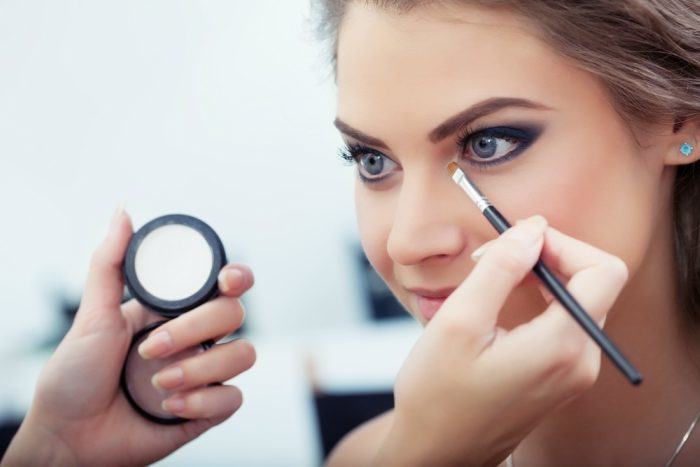 woman applying eyeshadow