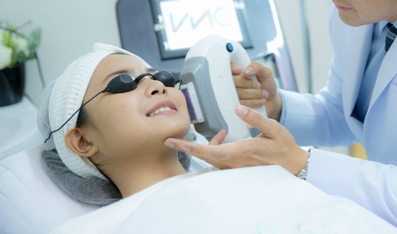 Laser Machine.Young woman receiving laser treatment