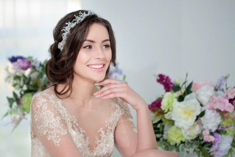 Portrait of beautiful girl in a luxurious wedding dress