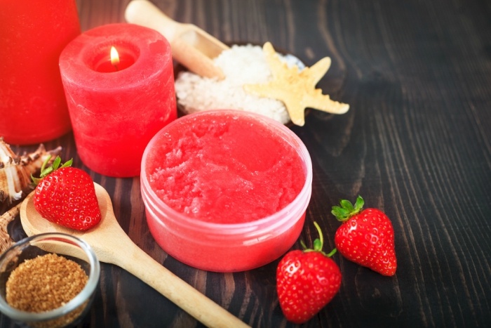 Strawberry body scrub with brown sugar and sea salt on the wooden background