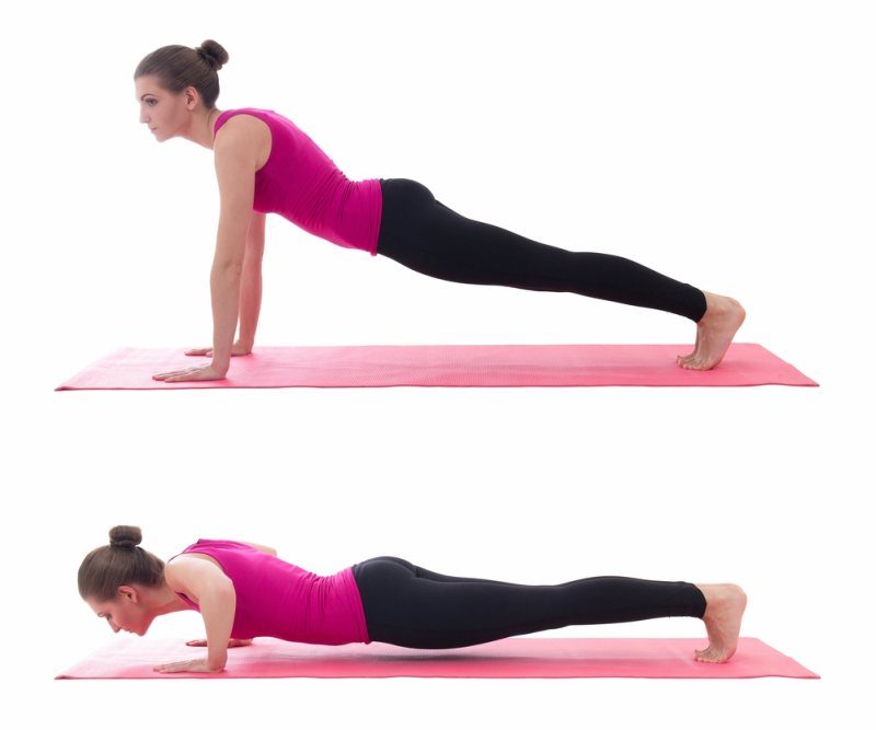 beautiful woman doing push up exercise on yoga mat isolated on white background