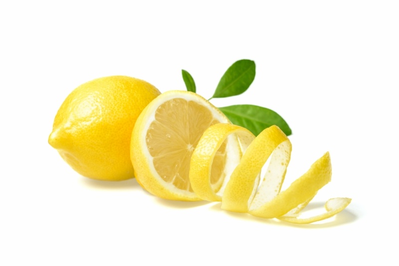 fresh lemon and lemon peel on white