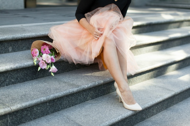 woman sitting on the stairs with flowers tutu skirt legs heel summer