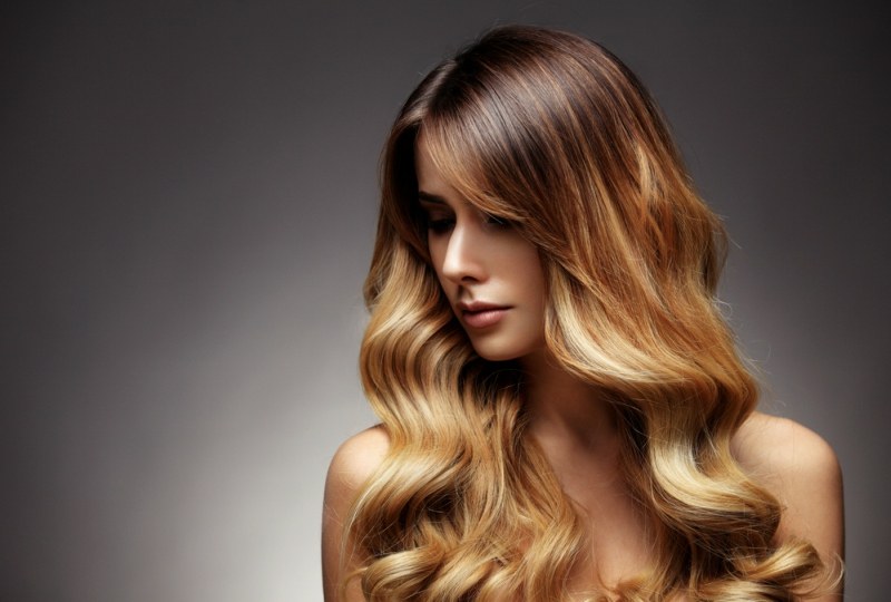 Beautiful blonde woman with long, healthy , straight and shiny hair. Hairstyle loose hair