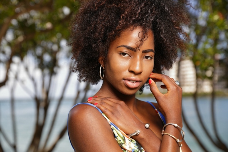 Headshot of a beautiful Caribbean woman with an afro