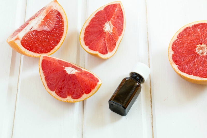 oil essential grapefruit in glass bottle with fresh grapefruit. Spa concept. Selective focus. essence, essential oil, extract, in amber glass bottle with dropper