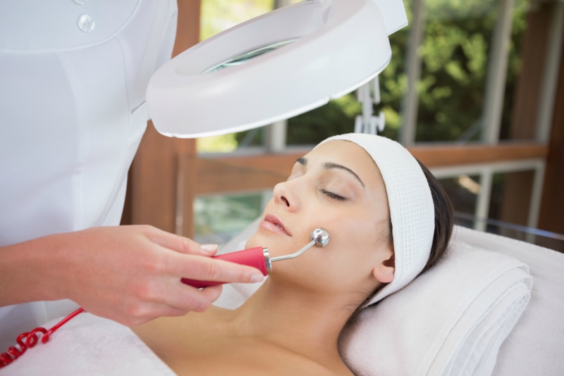 Peaceful brunette getting micro dermabrasion from beauty therapist in the health spa
