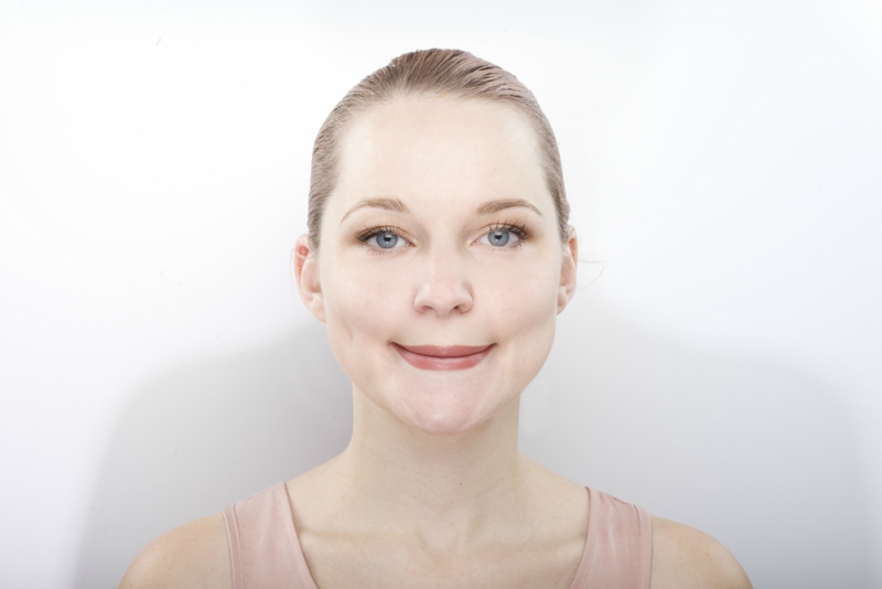 facial gymnastics. the girl does massage and rejuvenating exercises for the face